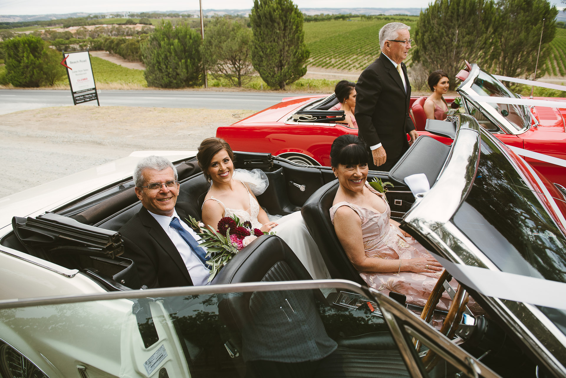 bride and parents in wedding car before ceremony 