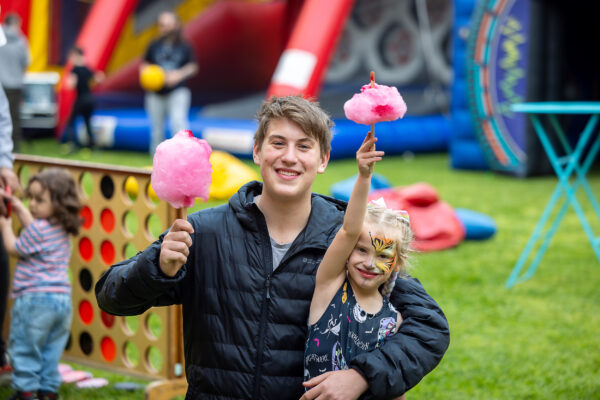 Young Carers event Photography with two young carers enjoying the event with fairyfloss