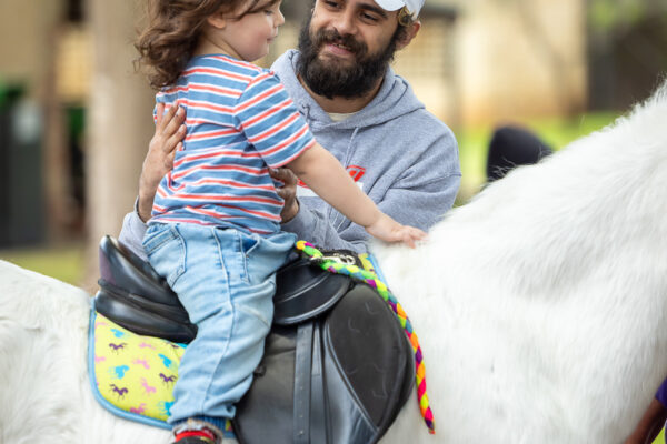 Young Carers Event photography showing a young carer on a pony