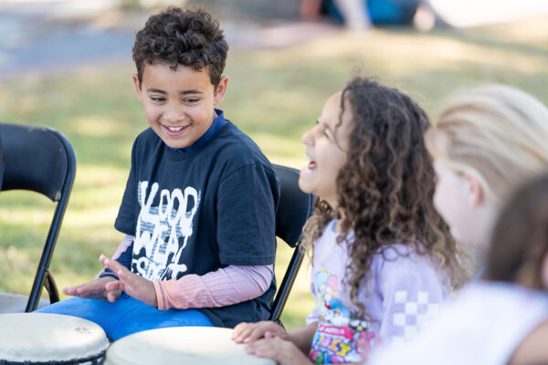 Young Carers Event photography showing young carers drumming at an event during the week