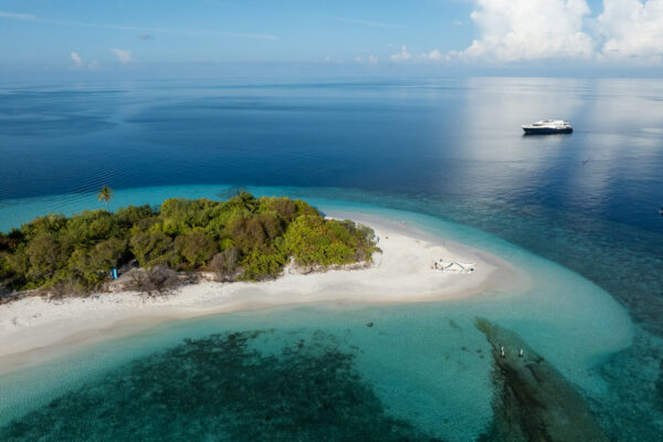 Scubaspa luxury liveaboard anchored in turquoise ocean waters of the Maldives