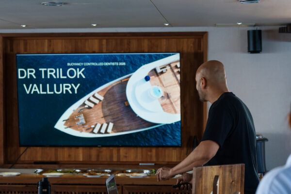 Close-up of Trilok Vallury presenter delivering keynote slides during liveaboard dental conference