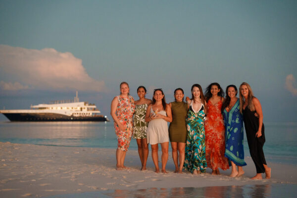 group of conference attendees during island visit for sunset dinner in the maldives