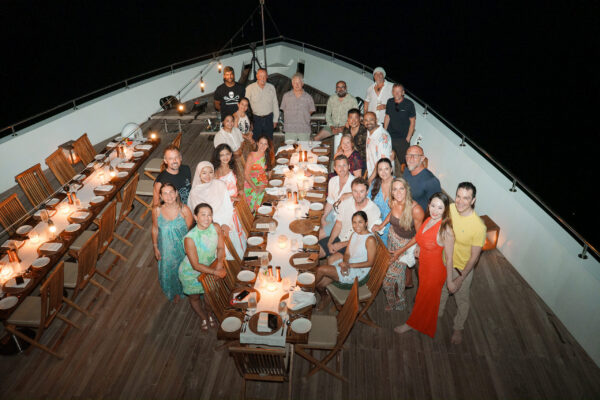 Group toast and evening celebration aboard luxury liveaboard venue